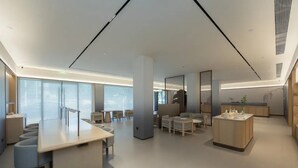 A modern hotel lobby with a long reception desk, seating area, and a small kitchenette. - JI Hotel Fuzhou Railway Station  (Fuzhou)