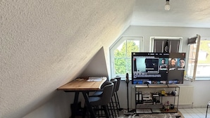 A room with a bed, a desk, and a TV.