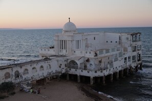 A coastal building with a dome, multiple windows, and a balcony overlooking the sea. - sandra 17 (Tunis)