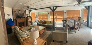 A spacious living area with a sofa, armchairs, a dining table, and a ceiling fan. - 3-bedroom, 2-bath house in beautiful downtown Bastrop.  Great yard and scenery. (Bastrop)