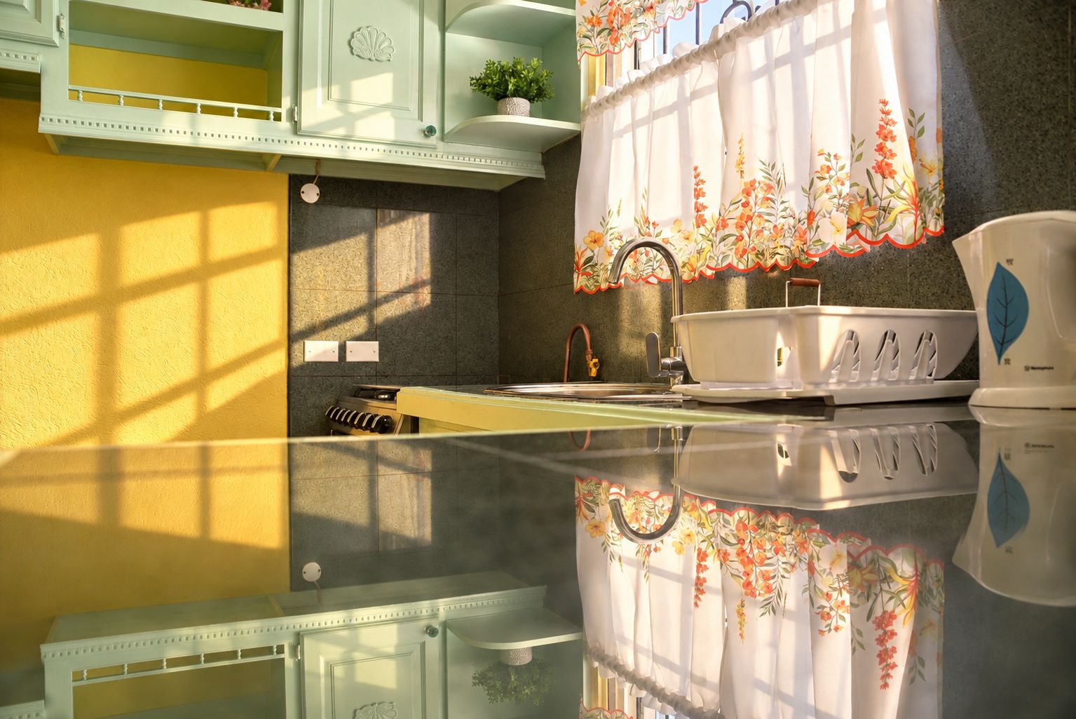 Una cocina con estufa, fregadero y ventana con cortina estampada.