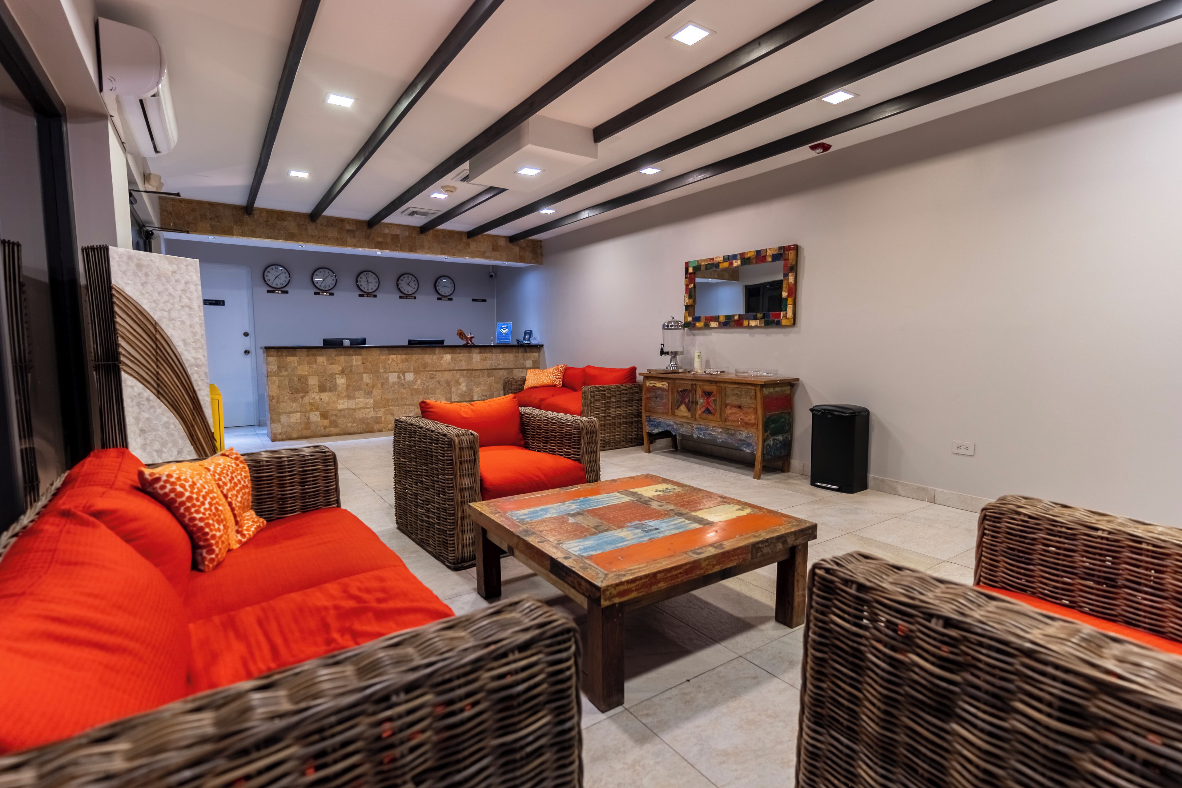 Ein modernes Wohnzimmer mit einer Couch, Sesseln, einem Couchtisch und einem Kamin.