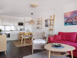 A modern living space with a kitchen, dining area, and seating area. - 5 Star Holiday Home in Uddevalla (Uddevalla)