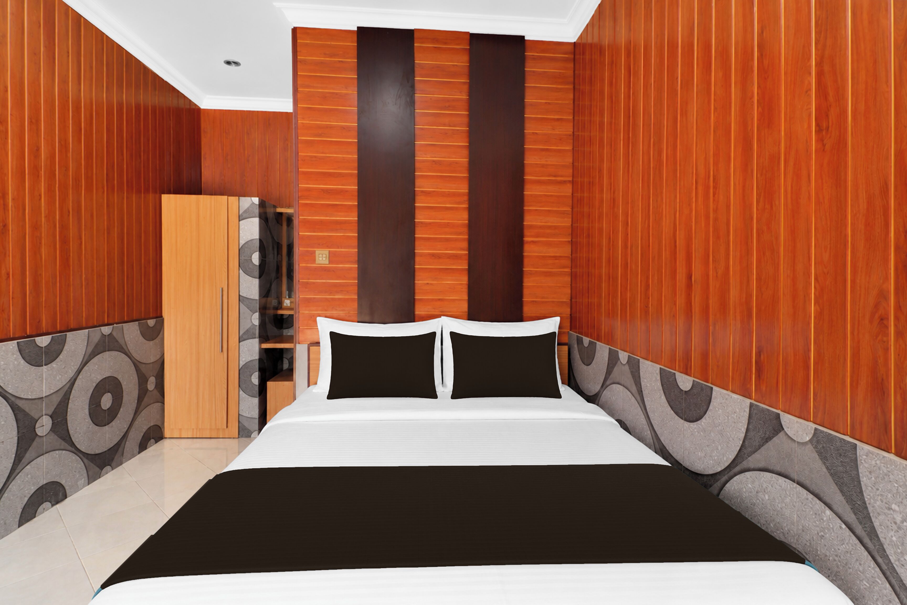 A bedroom with a bed, a wardrobe, and a mirror.