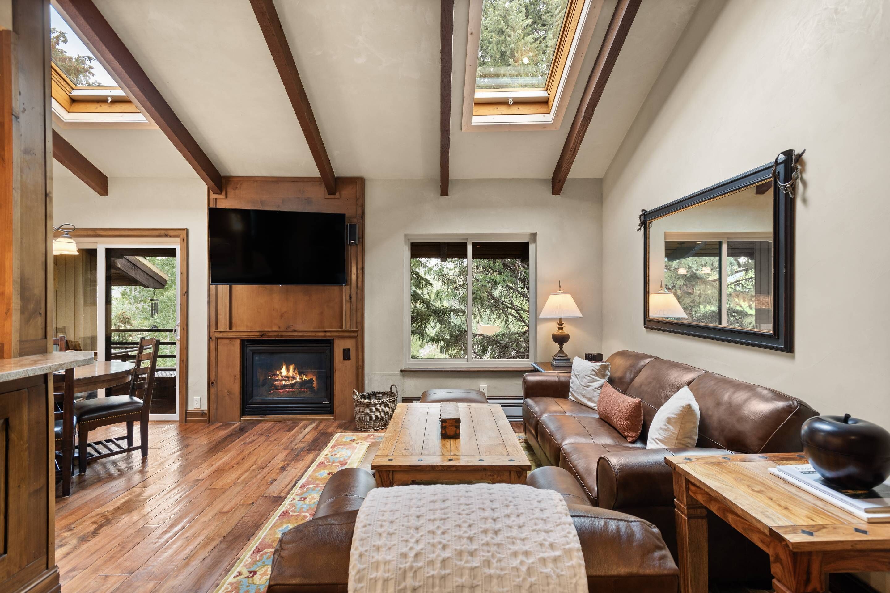 Vaulted ceilings with skylights and large pine trees out front create such an inviting retreat.