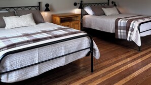 A bedroom with two beds, wooden flooring, and recessed ceiling lights. - Charming 3-bedroom House on a Cherry Orchard (Suttons Bay)