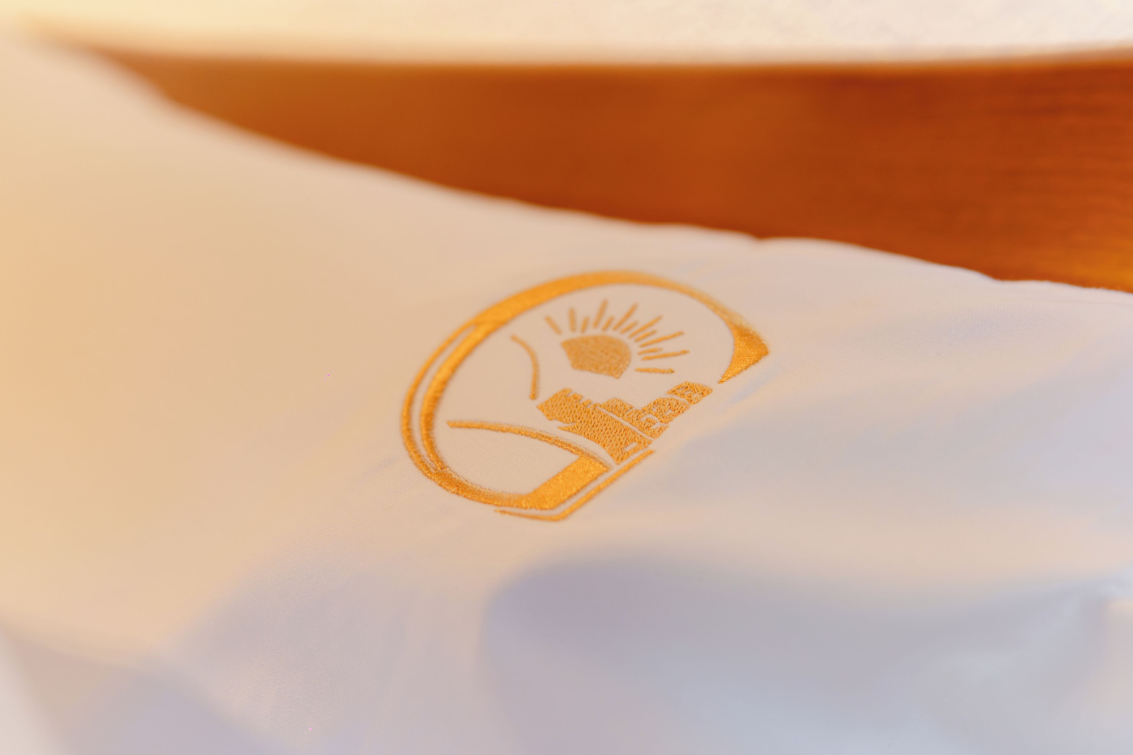 Un primo piano di un tessuto bianco con un logo.