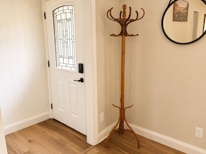 A white door with a glass panel and a coat stand with a curved base. - Family friendly spacious 4 bed 3 BA house in West Asheville (Candler)