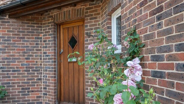 A brick building with a wooden door and a window. - Huge Peaceful 3Bed With FREE Parking (West Sussex)