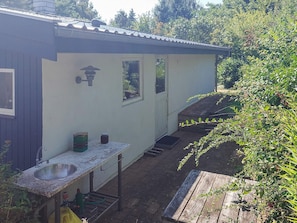 A house with a kitchen area, including a sink and a window.