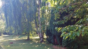 A well-maintained grassy area with trees and shrubs, likely part of a garden or park. - 4 Star Holiday Home in Hundested (Hundested)
