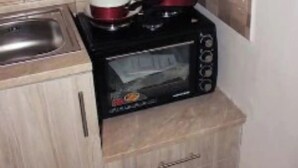 A compact kitchen with a microwave, a small oven, and a sink. - Amazing Studio 9 Minutes wak From Center (Thessaloniki)
