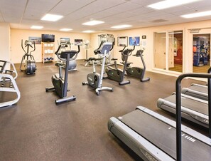 A gym with treadmills, elliptical machines, and a weight machine. - Seaside!! Condo with view, Balcony, Grill, just steps to the beach! (Seaside)