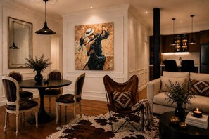 A dining area with a round table, chairs, a cowhide rug, and a painting on the wall. - River Haven | Walk Puerto Madero Dock, Casino BA (Buenos Aires)