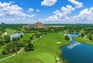 A golf course with a large building in the background. - Luxury Disney Retreat: Private Pool + ChampionsGate Resort Access (Davenport)