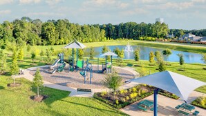 A playground with slides and climbing structures, a fountain, and picnic tables. - Modern 3br/2.5ba • 3 king bed • Gameroom • Pets OK (Montgomery)