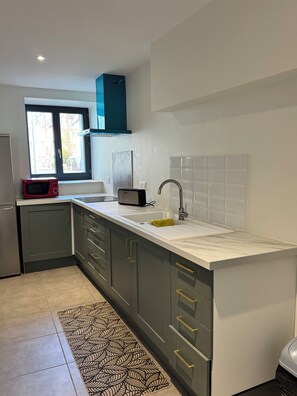 Una cucina moderna con forno a microonde integrato, un lavello e una finestra.