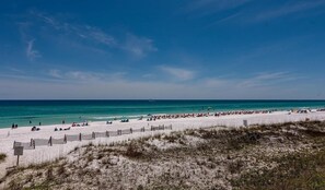 A beach with a fence, people, and umbrellas. - The Scenic Retreat at Ciboney 4010 - Gulfview - 3-bedroom - Pet Friendly (Miramar Beach)