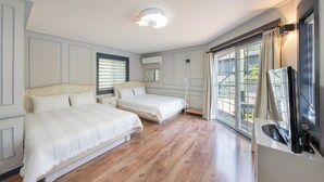 A bedroom with two beds, a large window with curtains, a flat-screen TV, and an air conditioning unit. - Hongcheon Tasha's Garden Pension (Hongcheon)