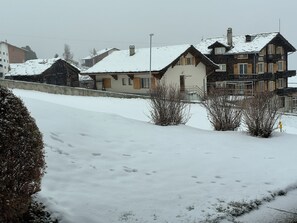 A snow-covered residential area with houses and a clear sky. - Nr. 20 - Haus Opal, (Grächen), by Interhome (Grächen)
