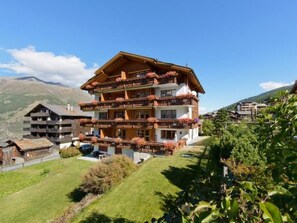 A multi-story chalet with balconies, set in a mountainous area. - Anna 33, (Grächen), 1307 by Interhome (Grächen)