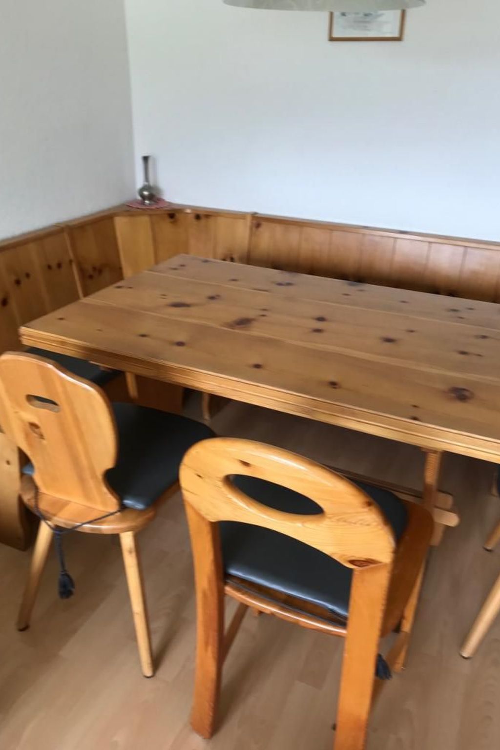 A corner dining area with a wooden table and two chairs.
