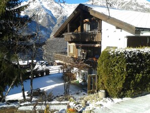 A chalet with a balcony overlooking a snowy landscape and a mountain in the background. - Schneevogul, (Grächen), 1114 by Interhome (Grächen)