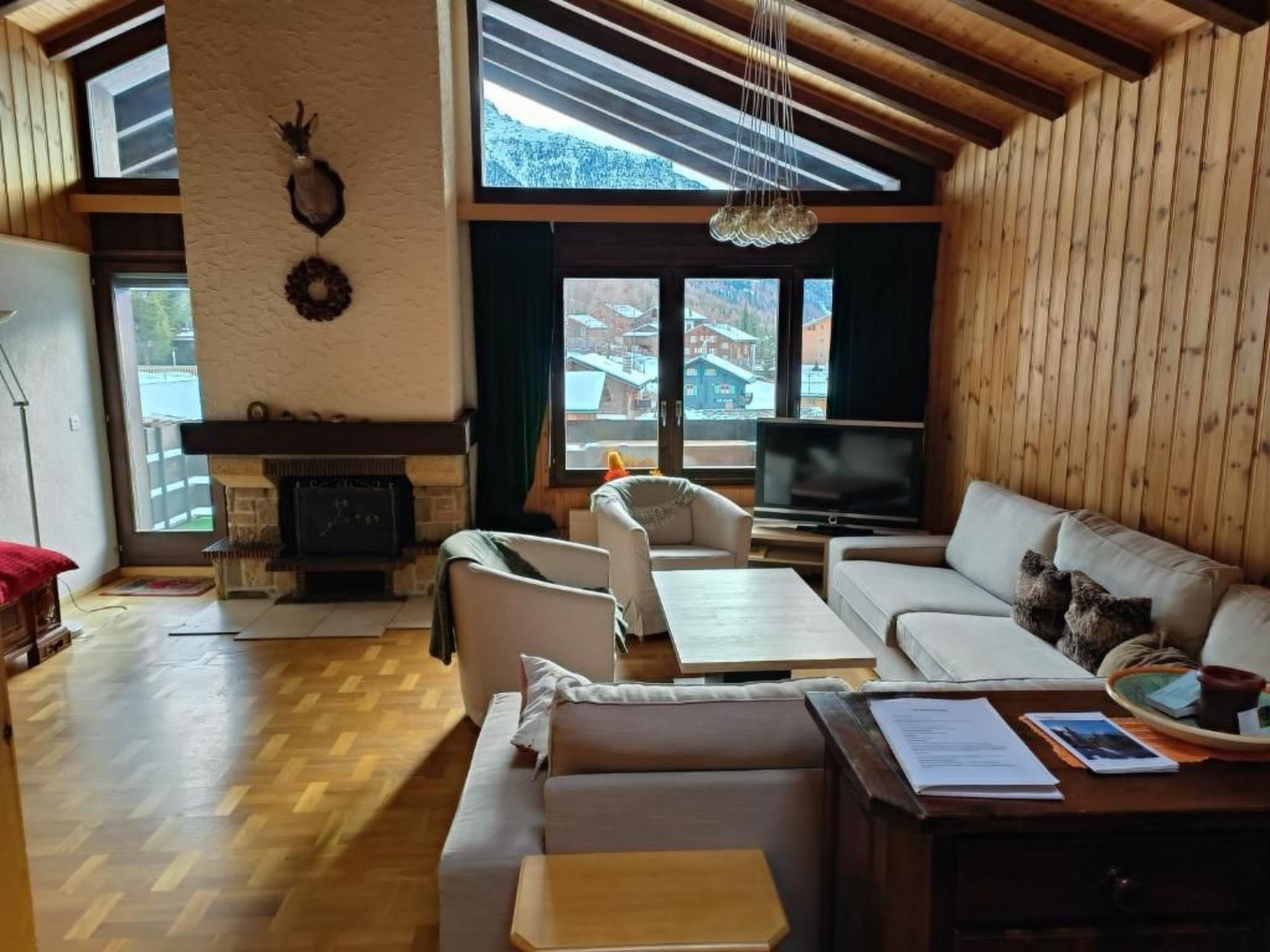 A cozy living room with a fireplace, comfortable seating, and a television.