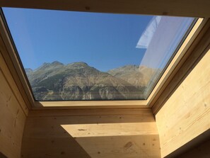 A skylight with a view of mountains. - Ferienwohnungen Chalet Safran, (Grächen), 1063 & 1594 by Interhome (Grächen)