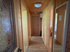 A narrow hallway with wooden walls and a ceiling light. - Chalet Heimatglück, (Grächen), 1179 - 1181 by Interhome (Grächen)