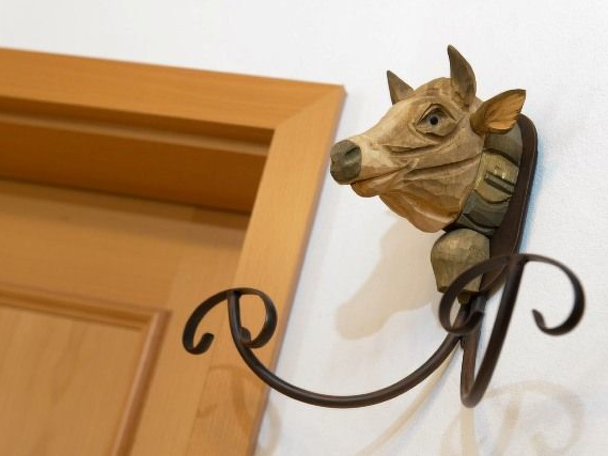 Une décoration murale représentant une tête d’animal, avec la lettre « P » placée en dessous.