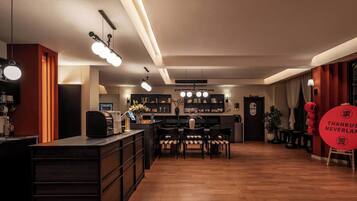 A modern interior with a bar area, seating, and a display of red lanterns.