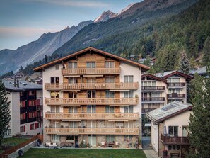 A multi-story hotel with balconies, set against a mountainous backdrop. - Haus Matterhorngruss, (Zermatt), 1583.00 by Interhome (Zermatt)