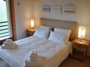 A hotel room with a bed, two bedside tables, and a window. - Résid. Sundance 15, (Les Crosets), A-0575 by Interhome (Les Crosets)
