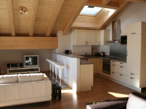 A modern kitchen with white cabinets, a built-in oven, and a skylight. - Résid. Sundance 15, (Les Crosets), A-0575 by Interhome (Les Crosets)