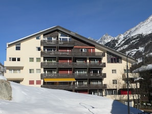 A multi-story hotel with balconies, set against a snowy mountain backdrop. - Haus Zayetta 1, Orange, (Zermatt), 1993.18 by Interhome (Zermatt)
