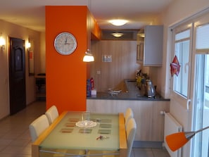 A modern kitchen with wooden cabinets, a stainless steel sink, and a window with blinds. - Haus Zayetta 1, Orange, (Zermatt), 1993.18 by Interhome (Zermatt)