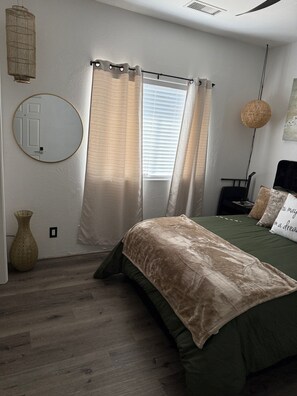 A bedroom with a bed, curtains, a round mirror, a hanging light, and a vase. - Comfortable Nature bedroom, Shared Newley Remodeled Space in tranquil Clarkdale (Clarkdale)