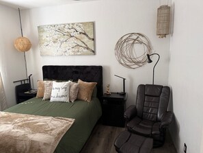 A bedroom with a bed, a chair, a nightstand, a lamp, and a wall art piece. - Comfortable Nature bedroom, Shared Newley Remodeled Space in tranquil Clarkdale (Clarkdale)