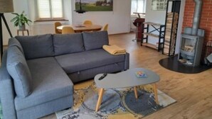 Una sala de estar moderna con un sofá gris, una mesita de centro y una chimenea.