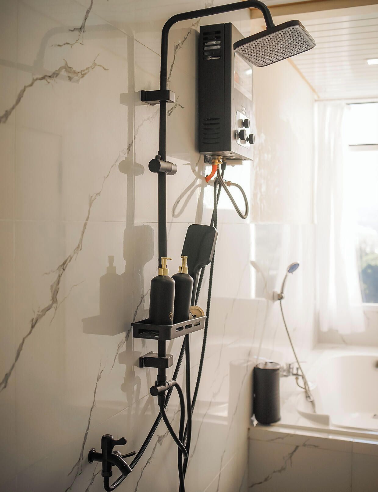 A bathroom with a shower, a handheld showerhead, a handheld shower attachment, and a handheld shower attachment.