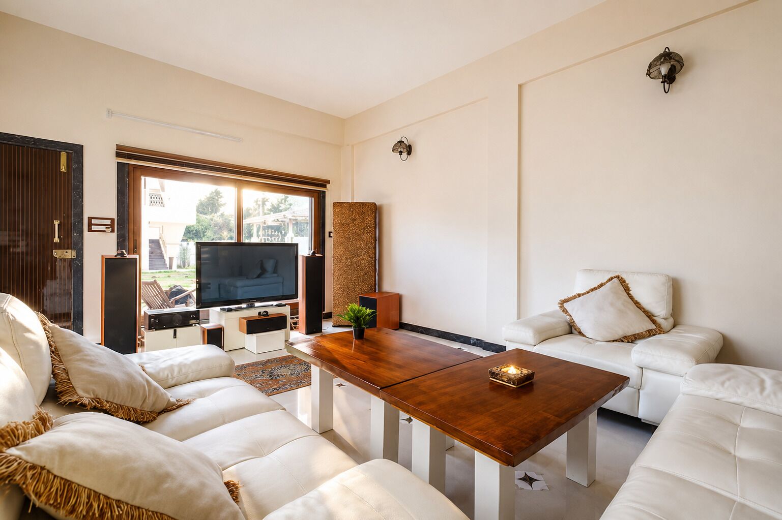A modern living room with a sofa, a coffee table, a TV, and a large window.