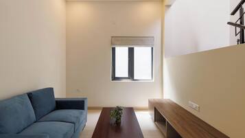 A modern living room with a sofa, a coffee table, and a bench.