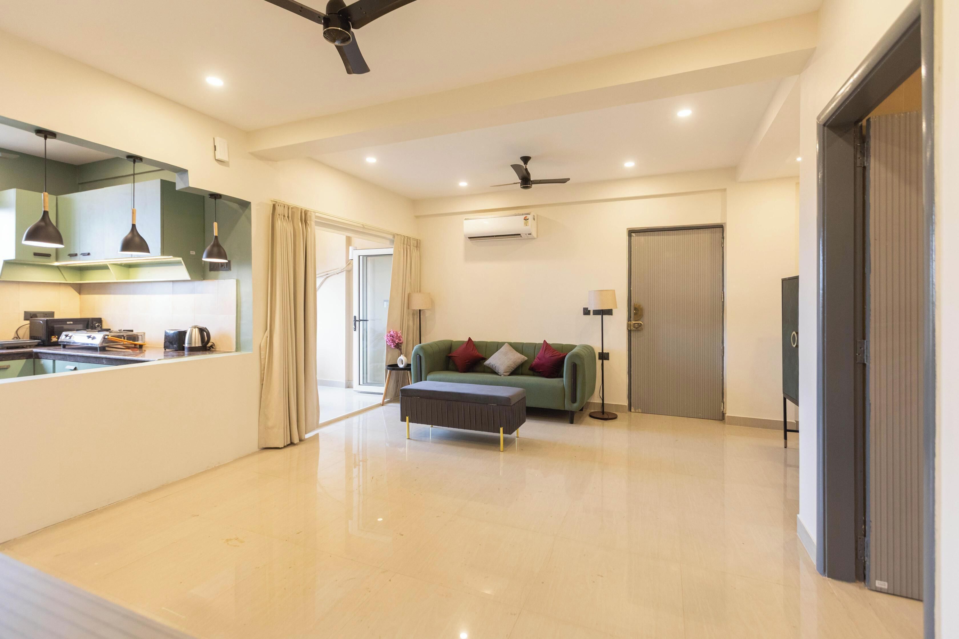 A modern living room with a sofa, a coffee table, and a ceiling fan.