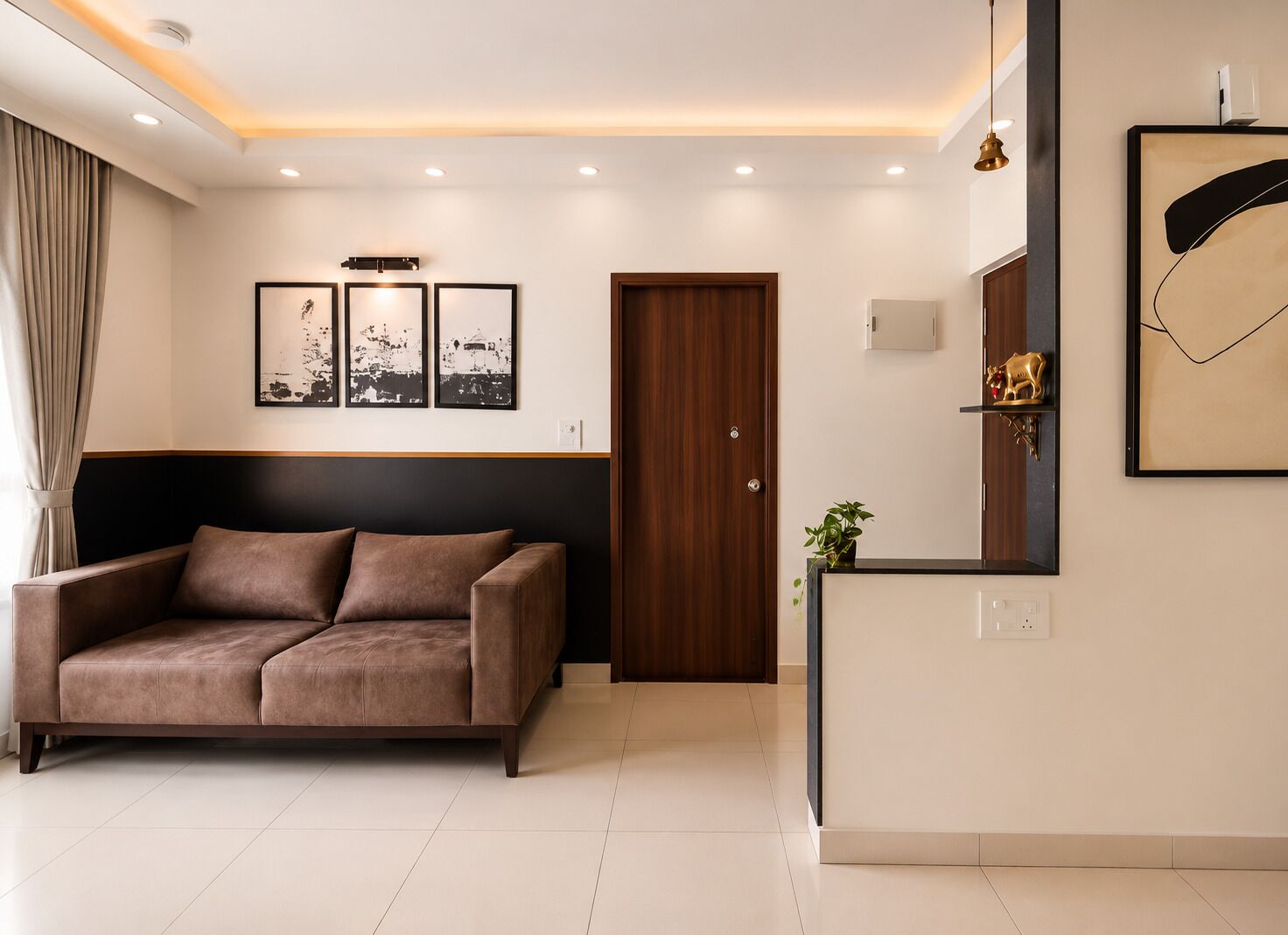 A modern living room with a sofa, a wooden door, a wall-mounted shelf with a plant, and framed artwork.