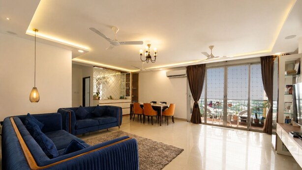 A modern living room with a sofa, dining table, chairs, and a balcony with plants. - Prism by Red Olive4 Bhkomrecr Beaches it Park (Tirupporur)