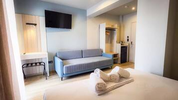 Triple Room, Balcony, City View | Desk, laptop workspace, blackout drapes, soundproofing