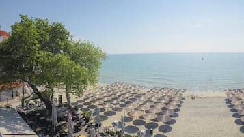 On the beach, white sand, beach umbrellas, beach bar
