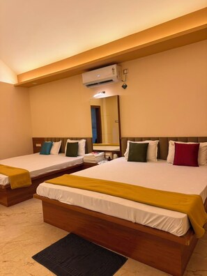 A hotel room with two beds, a large mirror, and an air conditioning unit. - Vrindavan Resort and Homestay Near Bhimashankar Road (Ambegaon)