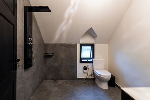 A modern bathroom with a shower, toilet, and a small window. - Orfeas Villas 2 Canggu Villa 2BR Pool (Canggu)